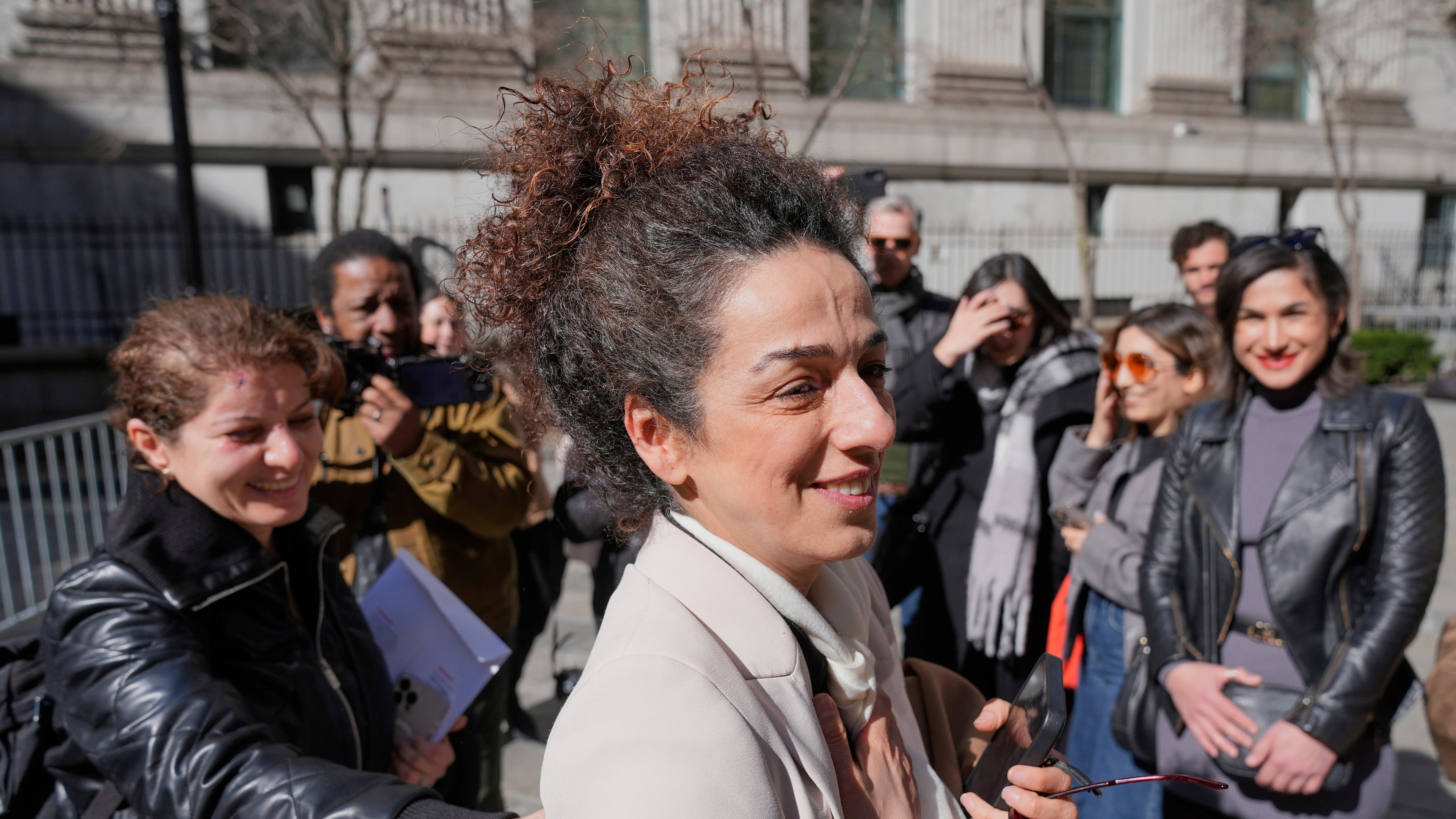 FILE - Masih Alinejad greets friends and supporters outside the federal courthouse after testifying at the trial of two men accused of allegedly plotting to kill her in New York, March 18, 2025. (AP Photo/Seth Wenig, File)
