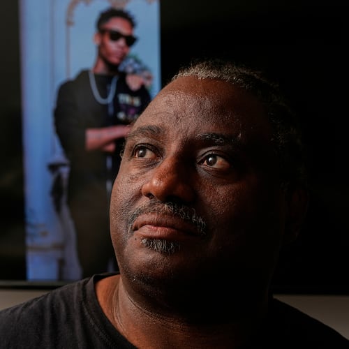Evaniel Johnson poses with a picture of his grandson, Tyrin Johnson, Monday, July 6, 2026, in Nashville, Tenn., after his grandson was fatally shot by two Tennessee National Guard members in Memphis on Sunday, morning. (AP Photo/George Walker IV)