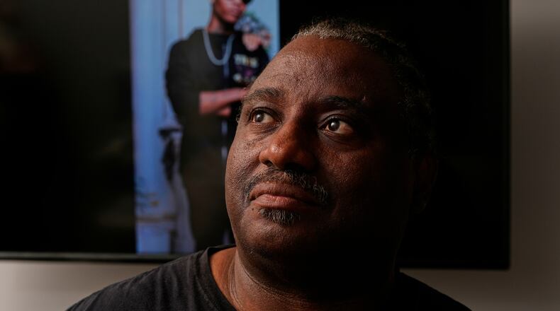 Evaniel Johnson poses with a picture of his grandson, Tyrin Johnson, Monday, July 6, 2026, in Nashville, Tenn., after his grandson was fatally shot by two Tennessee National Guard members in Memphis on Sunday, morning. (AP Photo/George Walker IV)