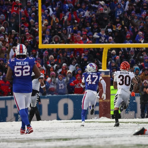 Buffalo Bills cornerback Christian Benford (47) runs for a touchdown after intercepting a pass by Cincinnati Bengals quarterback Joe Burrow (9) during the second half of an NFL football game, Sunday, Dec. 7, 2025, in Orchard Park, N.Y. Also seen are Buffalo Bills defensive tackle Jordan Phillips (52), Cincinnati Bengals running back Chase Brown (30) and Buffalo Bills defensive end Greg Rousseau (50). (AP Photo/Jeffrey T. Barnes)