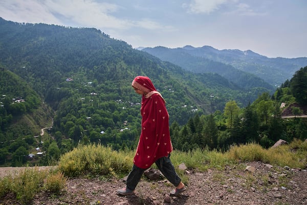 A Kashmiri villager woman walks towards her home at Tilawari village, near the Line of Control, north of Srinagar, Indian controlled Kashmir, Friday, May 2, 2025. (AP Photo/Dar Yasin)