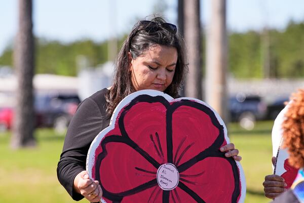 A supporter holds a sign outside the Central Louisiana ICE Processing Center in Jena, La., after an immigration hearing for Mahmoud Khalil, the Columbia University activist facing deportation for his role in pro-Palestinian campus protests, Friday, April 11, 2025. (AP Photo/Gerald Herbert)