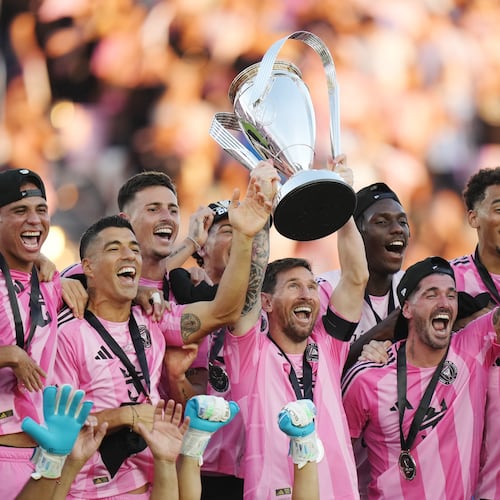 Inter Miami's Lionel Messi hoists the trophy alongside teammates after defeating the Vancouver Whitecaps in the MLS Cup final soccer match, in Fort Lauderdale, Fla., Saturday, Dec. 6, 2025. (Darryl Dyck/The Canadian Press via AP)
