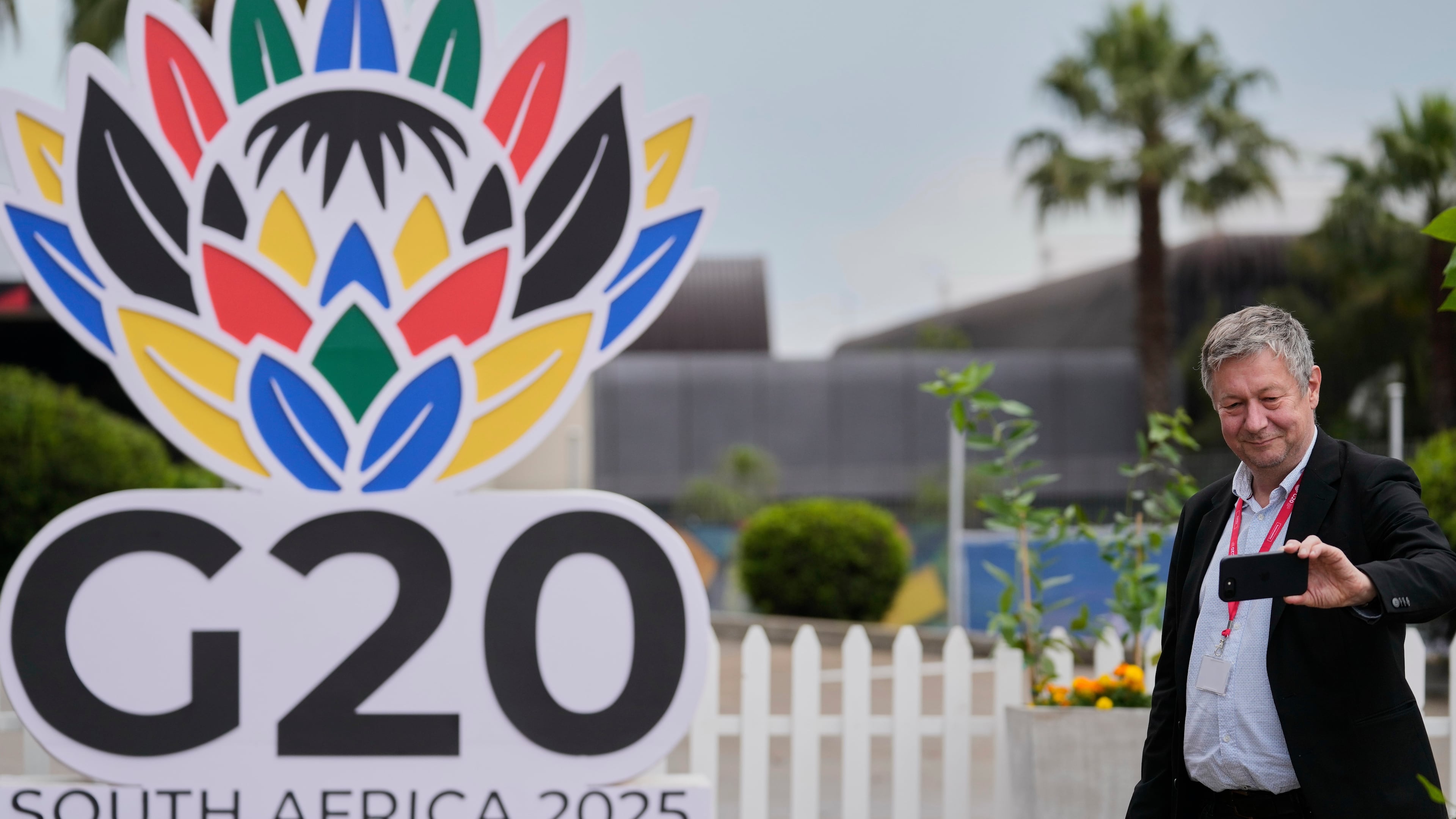 A journalist takes a selfie outside the media centre of the G20 Summit in Johannesburg, South Africa, Friday, Nov. 21, 2025. (AP Photo/Themba Hadebe)