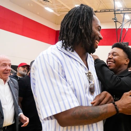 Kyle Lowry, right, speaks with Kawhi Leonard after a press conference in which Lowry signed a one-day contract to retire as a Toronto Raptor, in Toronto, on Tuesday, July 7, 2026. (Chris Young/The Canadian Press via AP)