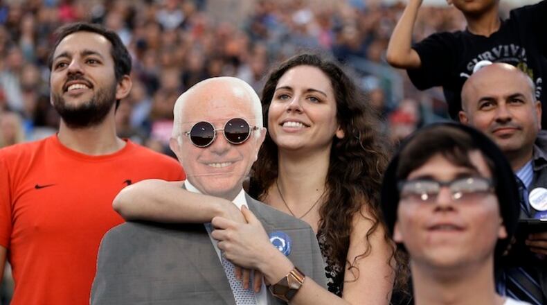 Kaitlin Cordova, center, holds a cardboard cutout of Democratic presidential candidate Sen. Bernie Sanders, I-Vt., during a rally on Tuesday, May 17, 2016, in Carson, Calif. (AP Photo/Jae C. Hong)