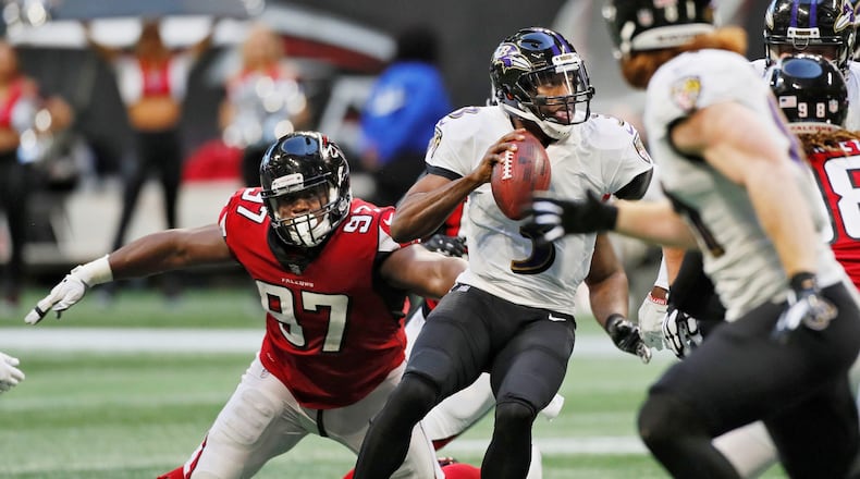 Ravens quarterback Robert Griffin III evades Falcons defensive tackle Grady Jarrett (97) in the second half Sunday, Dec. 2, 2018, at Mercedes-Benz Stadium in Atlanta.
