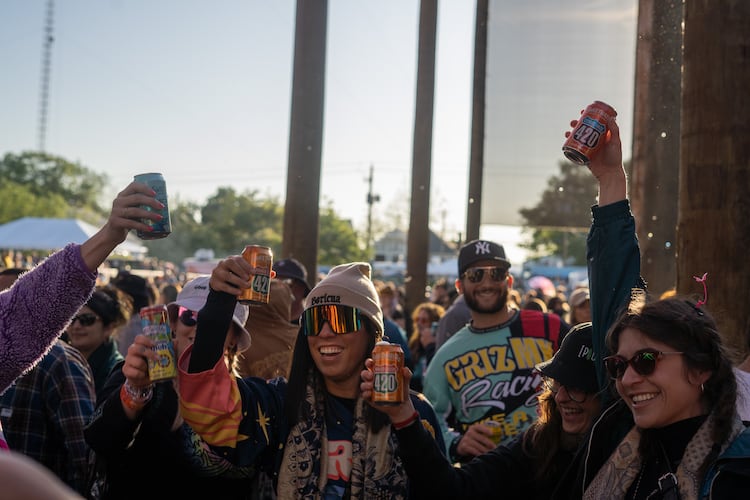 Festivalgoers hoist cold beers at SweetWater 420 Fest. (Courtesy of SweetWater Brewing Co.)
