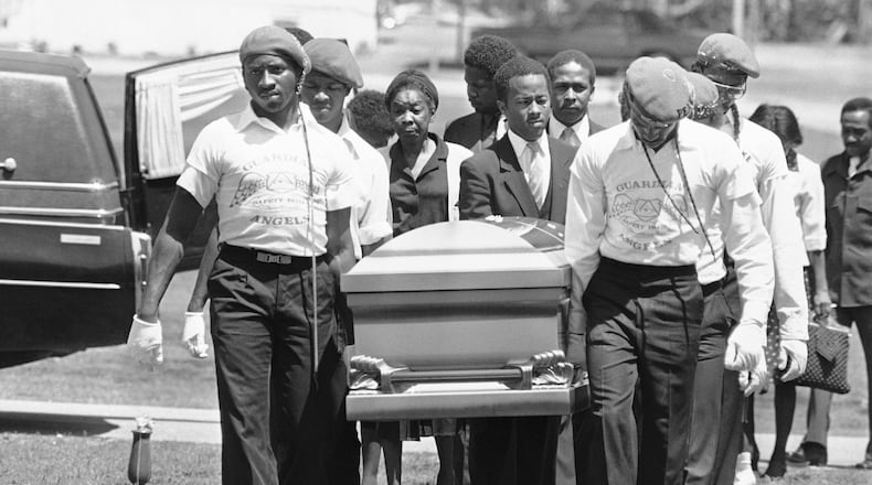 Casket containing Michael Cameron McIntosh, 23, the 25th victim in Atlanta?s string of slayings of young black is carried by members of the Guardian Angels and relatives during funeral services in Atlanta, Monday, April 27, 1981. His mother, Mrs. Hazel Matthews, third from left, follows the casket. (AP Phtoo/Sebo)