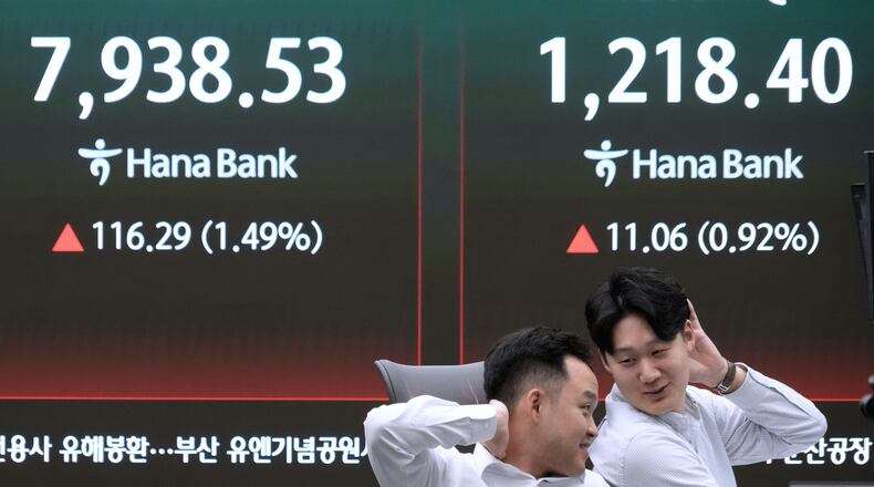 Currency traders react near a screen showing the Korea Composite Stock Price Index (KOSPI), left, at the foreign exchange dealing room of the Hana Bank headquarters in Seoul, South Korea, Tuesday, May 12, 2026. (AP Photo/Ahn Young-joon)