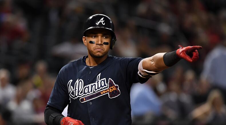 PHOENIX, AZ - JULY 25:  Johan Camargo #17 of the Atlanta Braves points to his teammates after hitting a eighth inning home run against the Arizona Diamondbacks at Chase Field on July 25, 2017 in Phoenix, Arizona. Braves won 8-3. (Photo by Norm Hall/Getty Images)
