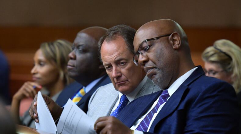 Fulton County Manager Dick Anderson and Dwight Robinson (right), Fulton County’s chief appraiser, share documentations as they listen to a plea to allow Fulton County to collect tax money. HYOSUB SHIN / HSHIN@AJC.COM AJC FILE PHOTO