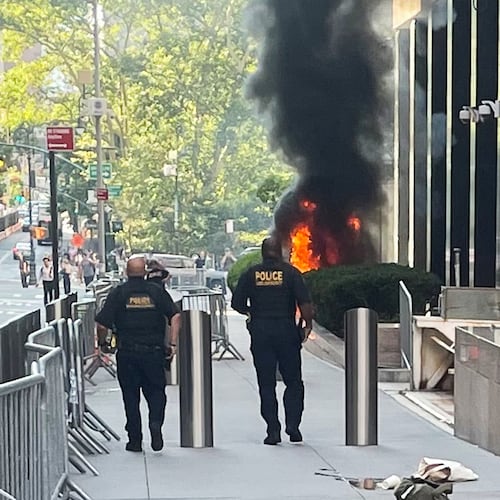 This photo provided by Robert Sullivan shows black smoke and flames in front of 26 Federal Plaza in lower Manhattan, Monday, July 20, 2026, in New York. (Robert Sullivan via AP)