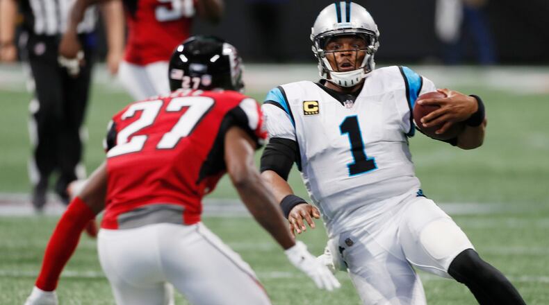 Panthers quarterback Cam Newton (1) starts to slide on a keeper as Atlanta Falcons cornerback Damontae Kazee (27) closes during the 2018 Panthers-Falcons matchup at Mercedes-Benz Stadium. (Bob Andres/AJC file photo)