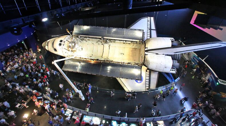 The public gathers around the Space Shuttle Atlantis exhibit on Saturday, June 29, 2013. (Red Huber/Orlando Sentinel/TNS)