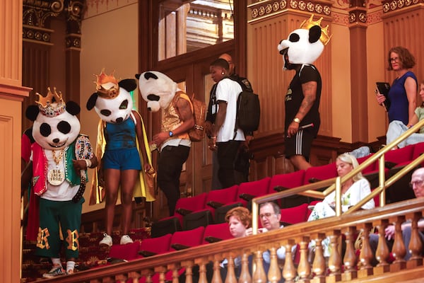 Rapper Big Jack Fross and the Heroes enter the gallery of the House of Representatives during the special session at the Capitol in Atlanta on Saturday. (Arvin Temkar/AJC)