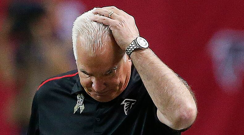 Mike Smith's Falcons could finish six games below .500 and still win the wretched NFC South. (AP Photo/John Bazemore)