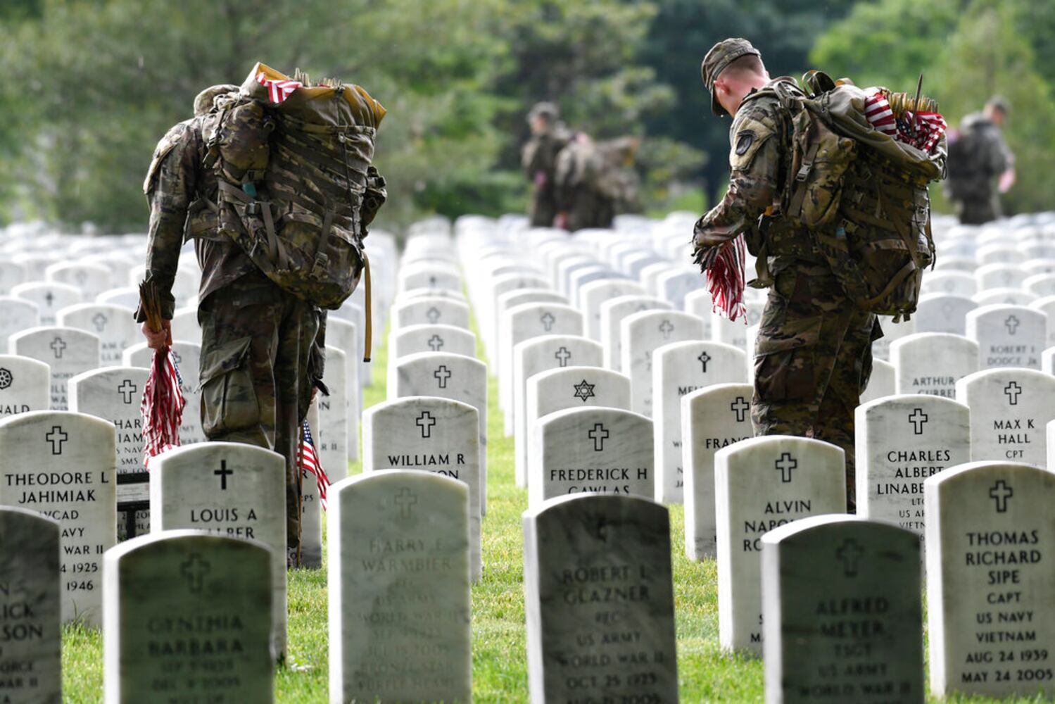 Soldiers place flags at Arlington National Cemetery for Memorial Day