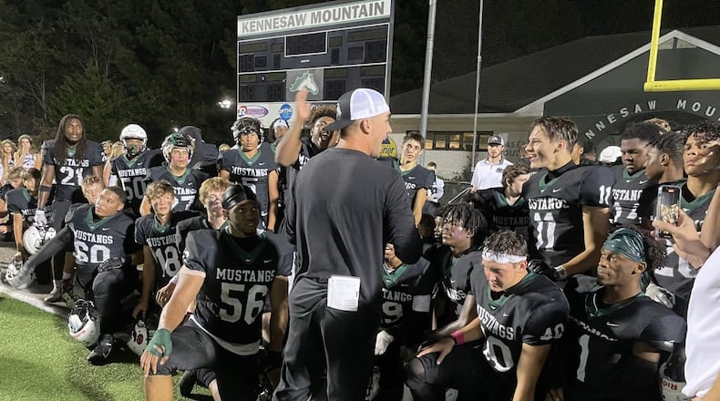 Kennesaw Mountain head coach Caleb Carmean talks to his team after its 21-17 victory over Pope in a Region 6-6A game on Oct. 15, 2021 (Photo by Chip Saye)