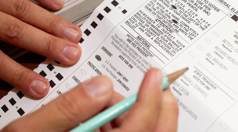 An Oregon voter casts a ballot from his home November 1, 2004 in Wilsonville, Oregon. In 2019, a group of legislators and activists in Oregon is seeking to lower the voting age from 18 to 16.