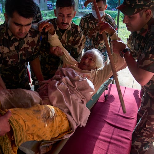 An elderly survivor is taken to a makeshift hospital for treatment at the army's Maithali barracks after being rescued from flash flooding in Nuwakot district, Nepal, Thursday, Aug. 27, 2026. (AP Photo/Niranjan Shrestha)