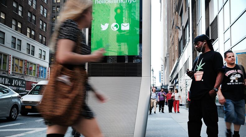 NEW YORK, NY - AUGUST 24: A man uses one of the new Wi-Fi kiosks that offer free web surfing, phone calls and a charging station on August 24, 2016 in New York City. The LinkNYC terminals, which number around 300 in Manhattan, have become especially popular with both the homeless and panhandlers. The free kiosks are being installed to replace obsolete pay phones around Manhattan. (Photo by Spencer Platt/Getty Images)
