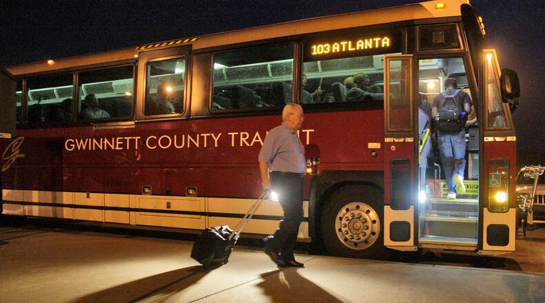 110922 - Lawrenceville - Riders board the express bus to downtown Atlanta in the early morning at the Discover Mills Park & Ride.  Gwinnett County - where residents have historically been averse to mass transit - will spend $1.1 million and 18 months studying the feasibility of various transit alternatives in the I-85 corridor.  Sep, 22, 2011  Bob Andres bandres@ajc.com