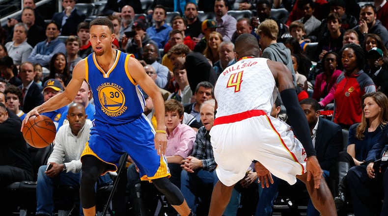Stephen Curry #30 of the Golden State Warriors drives against Paul Millsap #4 of the Atlanta Hawks at Philips Arena on February 22, 2016 in Atlanta. (Photo by Kevin C. Cox/Getty Images)