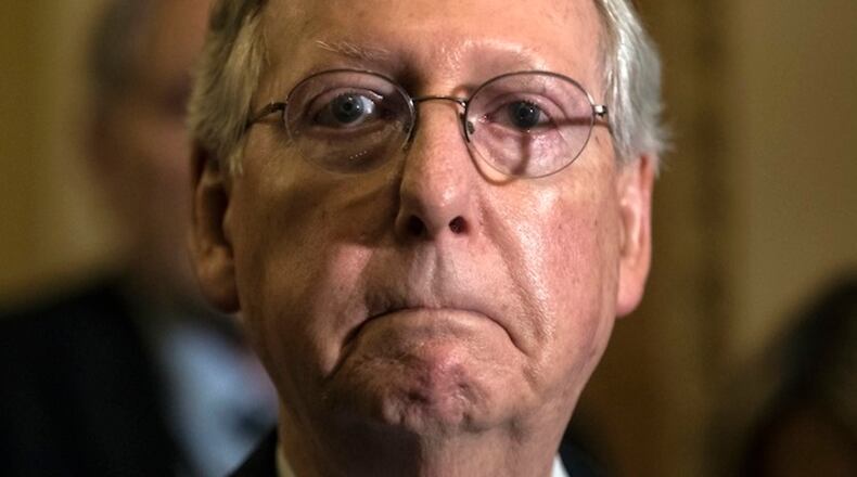 Senate Majority Leader Mitch McConnell, R-Ky., tells reporters he is delaying a vote on the Republican health care bill while GOP leadership works toward getting enough votes, at the Capitol in Washington, Tuesday, June 27, 2017. In a bruising setback, Senate Republican leaders are delaying a vote on their prized health care bill until after the July 4 recess, forced to retreat by a GOP rebellion that left them lacking enough votes to even begin debating the legislation, two sources said Tuesday. (AP Photo/J. Scott Applewhite)