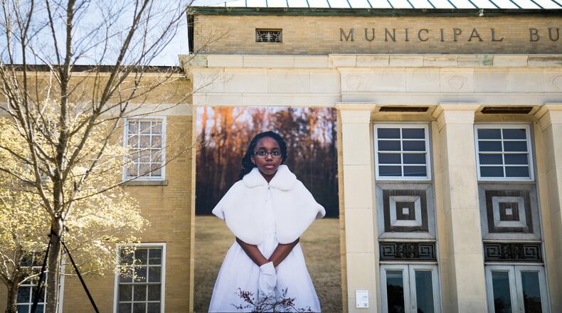 Ariel McCullough, dressed in her cotillion outfit, is featured in the photo mural installation “Seeing Newnan.” Contributed by Mary Beth Meehan