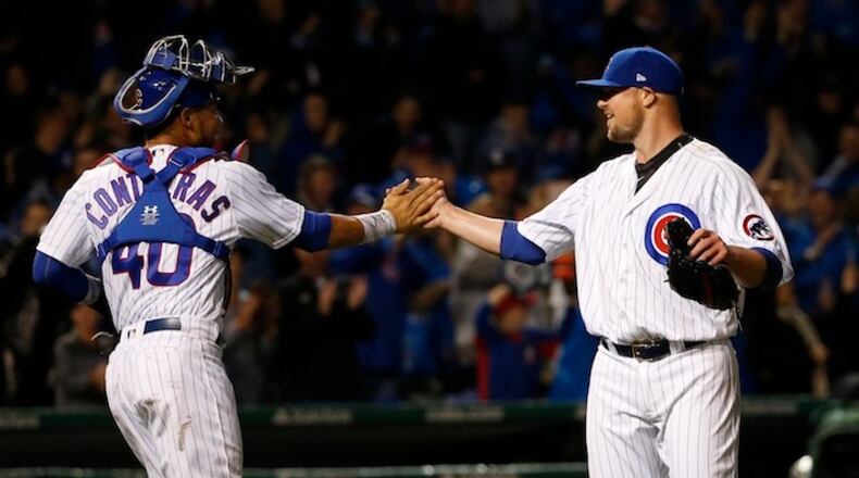 Chicago Cubs catcher Willson Contreras (40) and starting pitcher Jon Lester celebrate the team's 4-1 win and Lester's complete game after a baseball game against the San Francisco Giants Tuesday, May 23, 2017, in Chicago. (AP Photo/Charles Rex Arbogast)