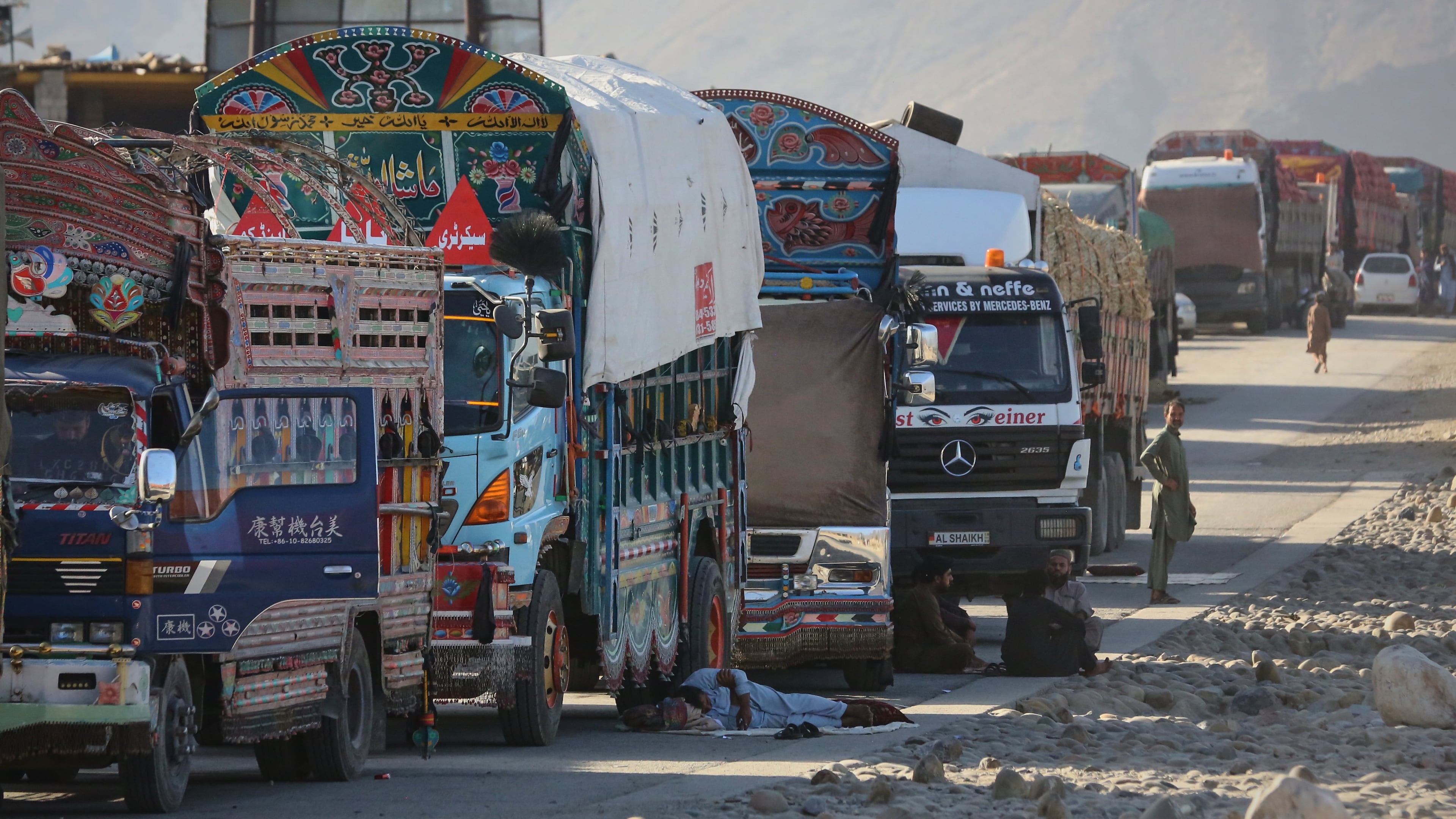 A line of cargo trucks bound for Pakistan is stranded on the Afghan side of the Torkham border crossing, which remained closed after clashes, in Nangarhar province, Afghanistan, Tuesday, Oct. 14, 2025. (AP Photo/Wahidullah Kakar)