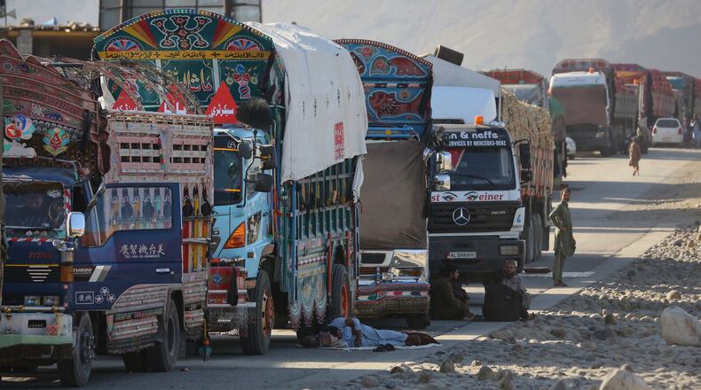 A line of cargo trucks bound for Pakistan is stranded on the Afghan side of the Torkham border crossing, which remained closed after clashes, in Nangarhar province, Afghanistan, Tuesday, Oct. 14, 2025. (AP Photo/Wahidullah Kakar)