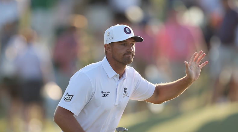 Bryson DeChambeau acknowledges patrons after his birdie putt on 18th hole during third round of the Masters golf tournament, at Augusta National Golf Club, Saturday, April 12, 2025, in Augusta, Ga. (Jason Getz / AJC)