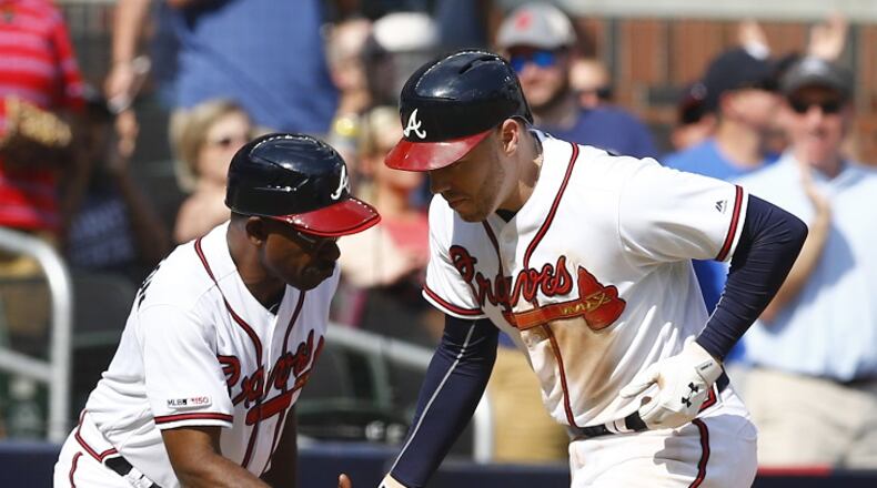 ATLANTA, GEORGIA - JUNE 01: First baseman Freddie Freeman #5 of the Atlanta Braves is congratulated by third base coach Ron Washington #37 after hitting a 2-run home run in the fourth inning during the game against the Detroit Tigers at SunTrust Park on June 01, 2019 in Atlanta, Georgia. (Photo by Mike Zarrilli/Getty Images)