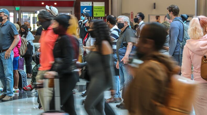 Hartsfield-Jackson International Airport is waiving fees and rents to help airlines and airport shops to reestablish services as people return to traveling. Lines at Hartsfield-Jackson International Airport stretched through the domestic terminal atrium and down hallways early Monday morning as travel ramps up in a recovery from the effects of COVID-19. (John Spink / John.Spink@ajc.com)