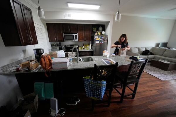 Shea Giagnorio packs belongings in her apartment days after getting fired from her job with the Administration for Children and Families, Monday, April 14, 2025, in Overland Park, Kan. (AP Photo/Charlie Riedel)