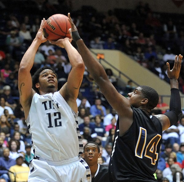 FOR 033014 hs boys poy STORY--MARCH 8, 2014 MACON Tift County Blue Devils Tadric Jackson #12 takes a shot over the defense of Wheeler Wildcats Elija Staley #14 during action in the first half. Coverage of the Class AAAAAA boys basketball championship between the Wheeler Wildcats and Tift County Blue Devils at the Macon Coliseum Saturday, March 8, 2014. Tift led 19-17 at the half. KENT D. JOHNSON / KDJOHNSON@AJC.COM Tadric Jackson, a Georgia Tech-bound guard who averaged nearly 25 points for his career until his senior season. (Kent D. Johnson / AJC)