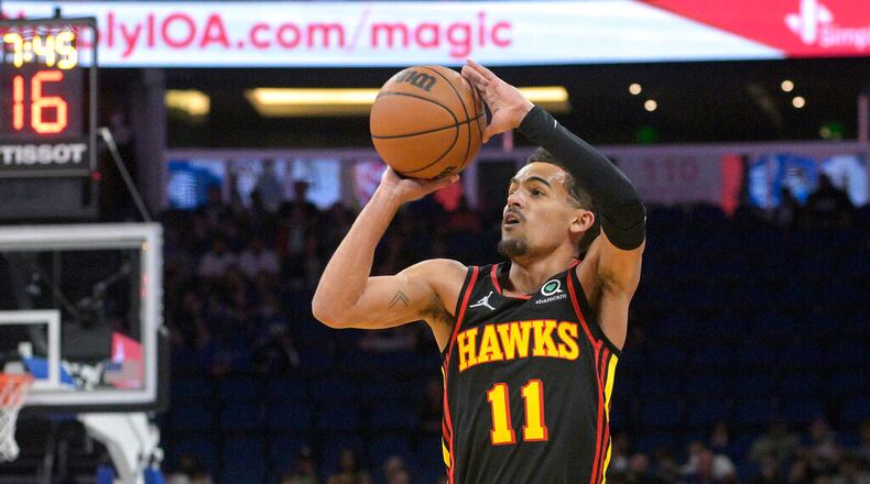 Atlanta Hawks guard Trae Young shoots a 3-pointer during the first half of the team's NBA basketball game against the Orlando Magic, Wednesday, Feb. 16, 2022, in Orlando, Fla. (AP Photo/Phelan M. Ebenhack)