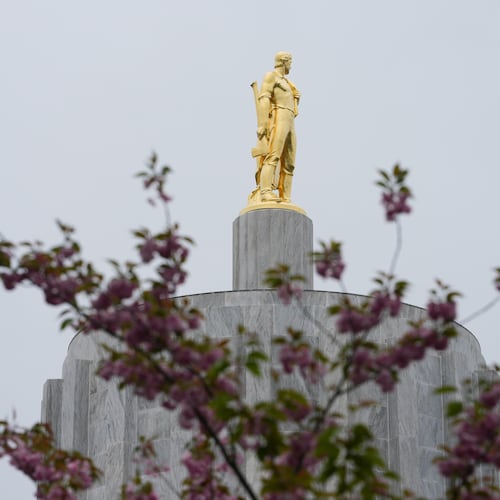FILE - The Oregon Pioneer statue is seen on top of the Oregon State Capitol building, April 14, 2026, in Salem, Ore. (AP Photo/Jenny Kane, File)