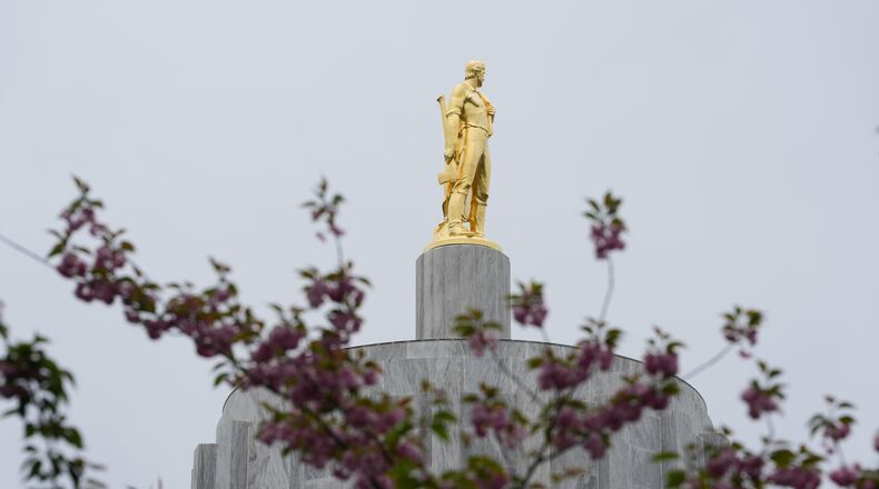 FILE - The Oregon Pioneer statue is seen on top of the Oregon State Capitol building, April 14, 2026, in Salem, Ore. (AP Photo/Jenny Kane, File)