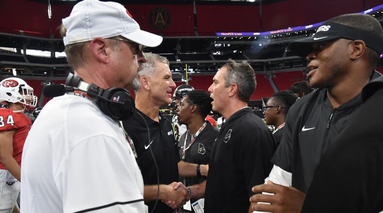 North Gwinnett head coach Bill Stewart (center left) and Colquitt County head coach Justin Rogers shake hands after Colquitt County won 17- 6 during the Corky Kell Classic at Mercedes-Benz Stadium on Saturday, August 24, 2019. (Hyosub Shin / Hyosub.Shin@ajc.com)