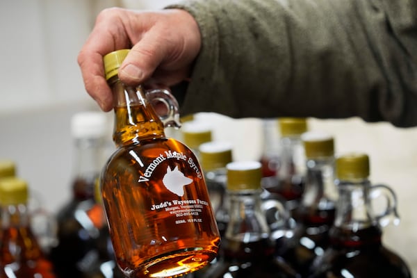 A bottle of maple syrup is placed on a shelf at Judd's Wayeeses Farms in Morgan, Vt., on Friday, April 11, 2025. (AP Photo/Robert F. Bukaty)