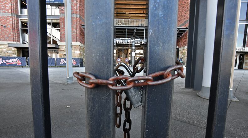 March 2, 2022 Atlanta - Third Base gates at Truist Park are locked on Wednesday, March 2, 2022. Six Braves games, all on the road, were canceled: the March 31 season opener against the Marlins in Miami, three more games in Miami through April 3 and two games against the Mets in New York on April 4-5. Still on the calendar for now – but endangered unless a deal is done within a week or so – is the Braves’ home opener April 7, when fans would welcome back the World Series champs to a sold-out Truist Park. (Hyosub Shin / Hyosub.Shin@ajc.com)