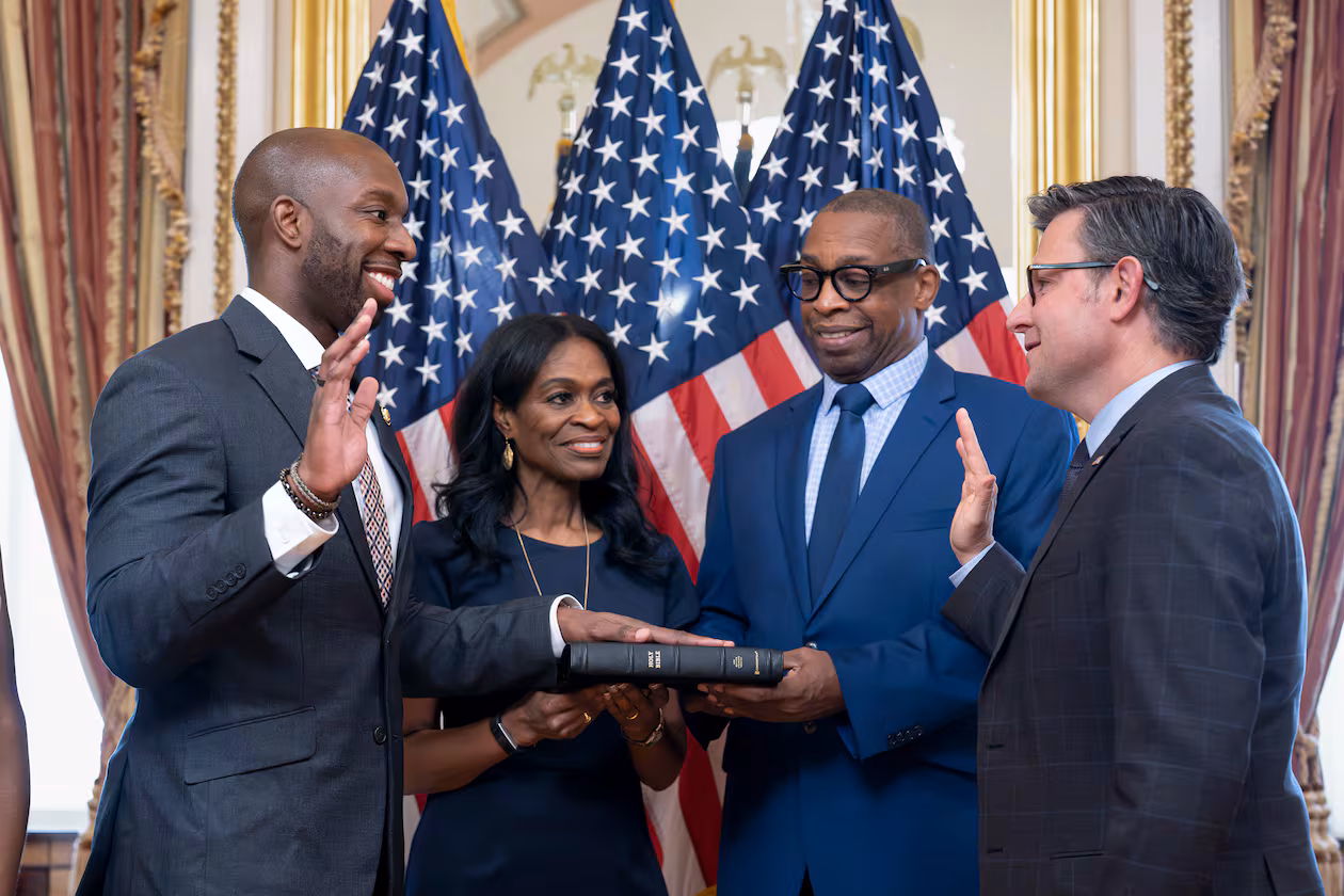 From left, new Rep. Everton Blair, D-Ga., joined by his mother Fiona Blair and father Everton Blair Sr., stands for a swearing-in ceremony with Speaker of the House Mike Johnson, R-La., after he won a special election to replace the late Georgia Rep. David Scott, at the Capitol in Washington, Tuesday, Sept. 1, 2026. (AP Photo/J. Scott Applewhite)