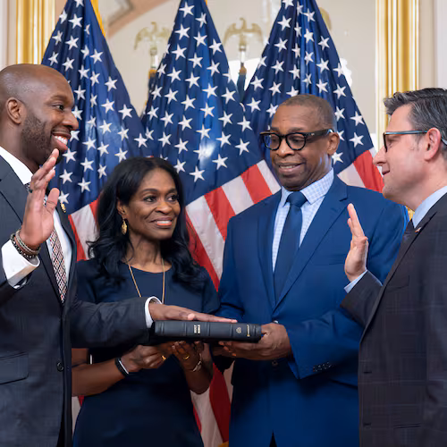 From left, new Rep. Everton Blair, D-Ga., joined by his mother Fiona Blair and father Everton Blair Sr., stands for a swearing-in ceremony with Speaker of the House Mike Johnson, R-La., after he won a special election to replace the late Georgia Rep. David Scott, at the Capitol in Washington, Tuesday, Sept. 1, 2026. (AP Photo/J. Scott Applewhite)