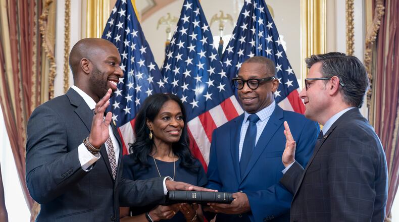 From left, new Rep. Everton Blair, D-Ga., joined by his mother Fiona Blair and father Everton Blair Sr., stands for a swearing-in ceremony with Speaker of the House Mike Johnson, R-La., after he won a special election to replace the late Georgia Rep. David Scott, at the Capitol in Washington, Tuesday, Sept. 1, 2026. (AP Photo/J. Scott Applewhite)