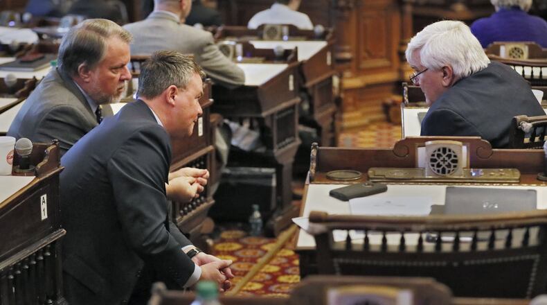 1/15/19 - Atlanta - Rep. Terry England (left), R - Auburn, Spiro Amburn, Speaker David Ralston's Chief of Staff, and Rep. Jay Powell. R - Camilla, confer on the House floor. Bob Andres / bandres@ajc.com