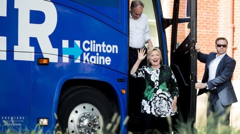 Democratic presidential candidate Hillary Clinton and Democratic vice presidential candidate Sen. Tim Kaine, D-Va., arrives at a rally at Fort Hayes Metropolitan Education Center in Columbus, Ohio, Sunday, July 31, 2016. Clinton and Kaine are on a three day bus tour through the rust belt. (AP Photo/Andrew Harnik)