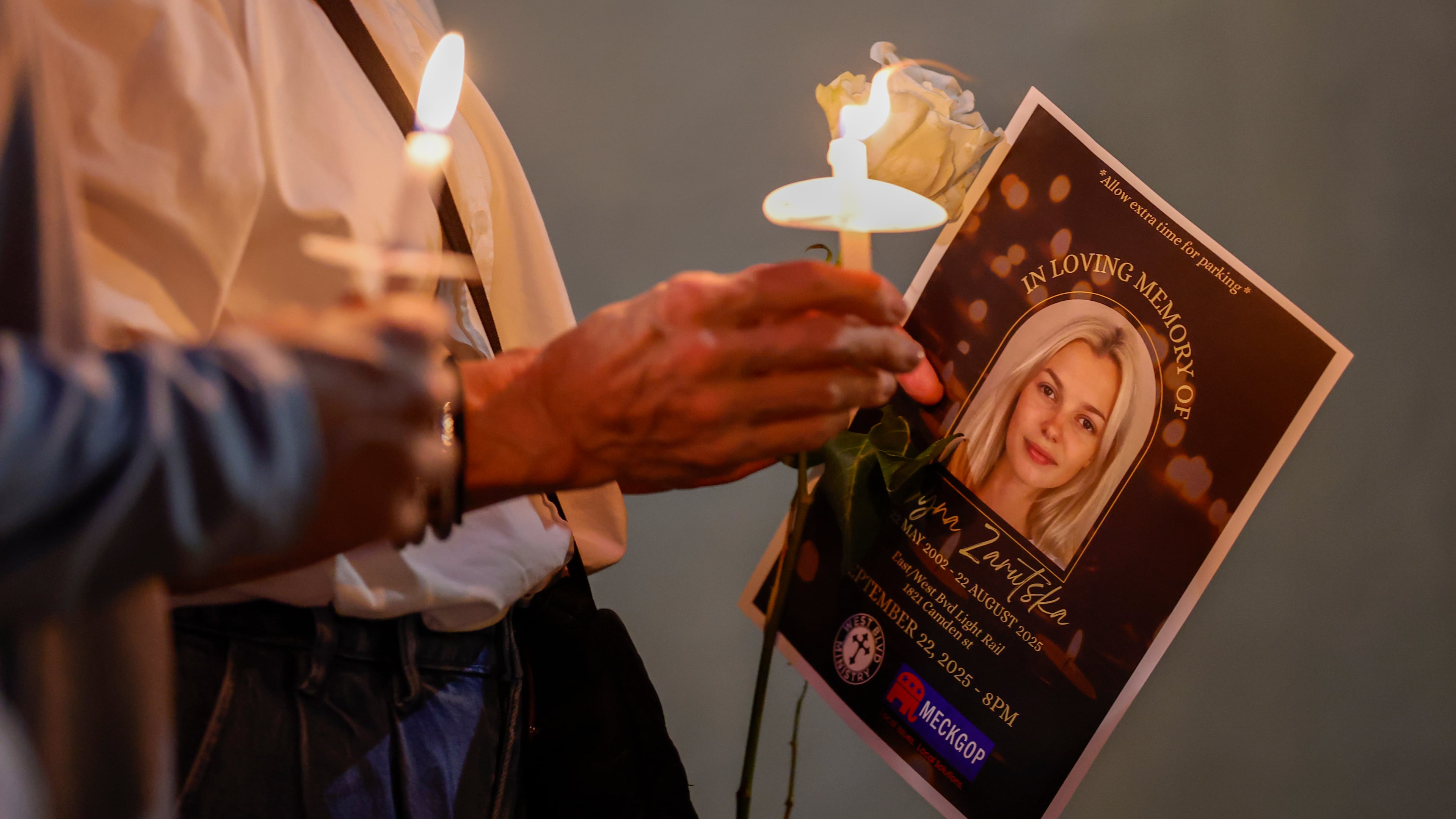Community members hold candles as they gather for a vigil honoring the life of Iryna Zarutska, who was fatally stabbed on a commuter train last month, Monday, Sept. 22, 2025, in Charlotte, N.C. (AP Photo/Nell Redmond)